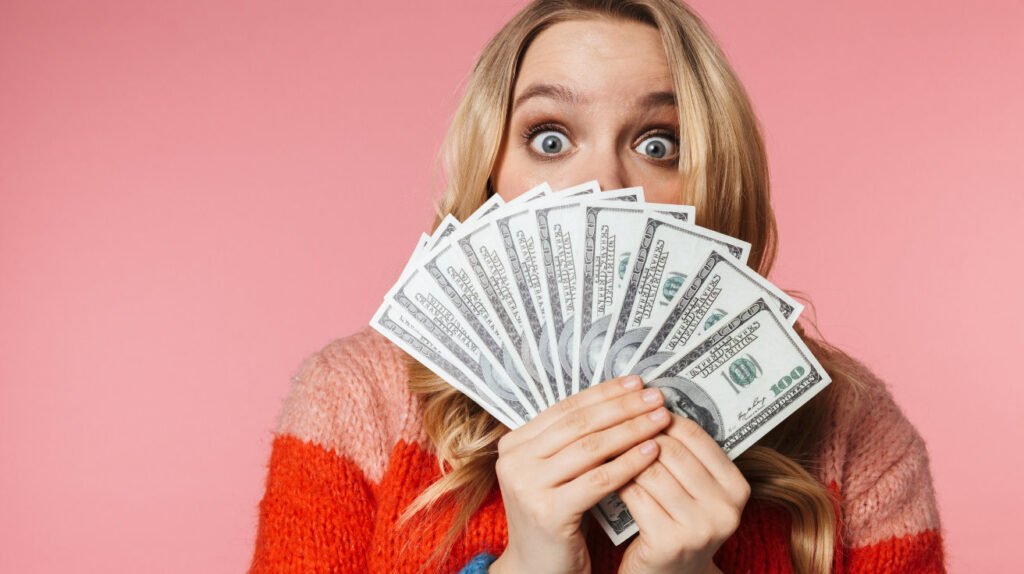 money saving methods , woman holding 100 dollar bills